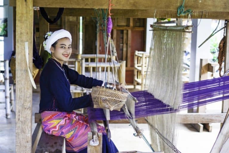 woman at handloom sewing machine thailand